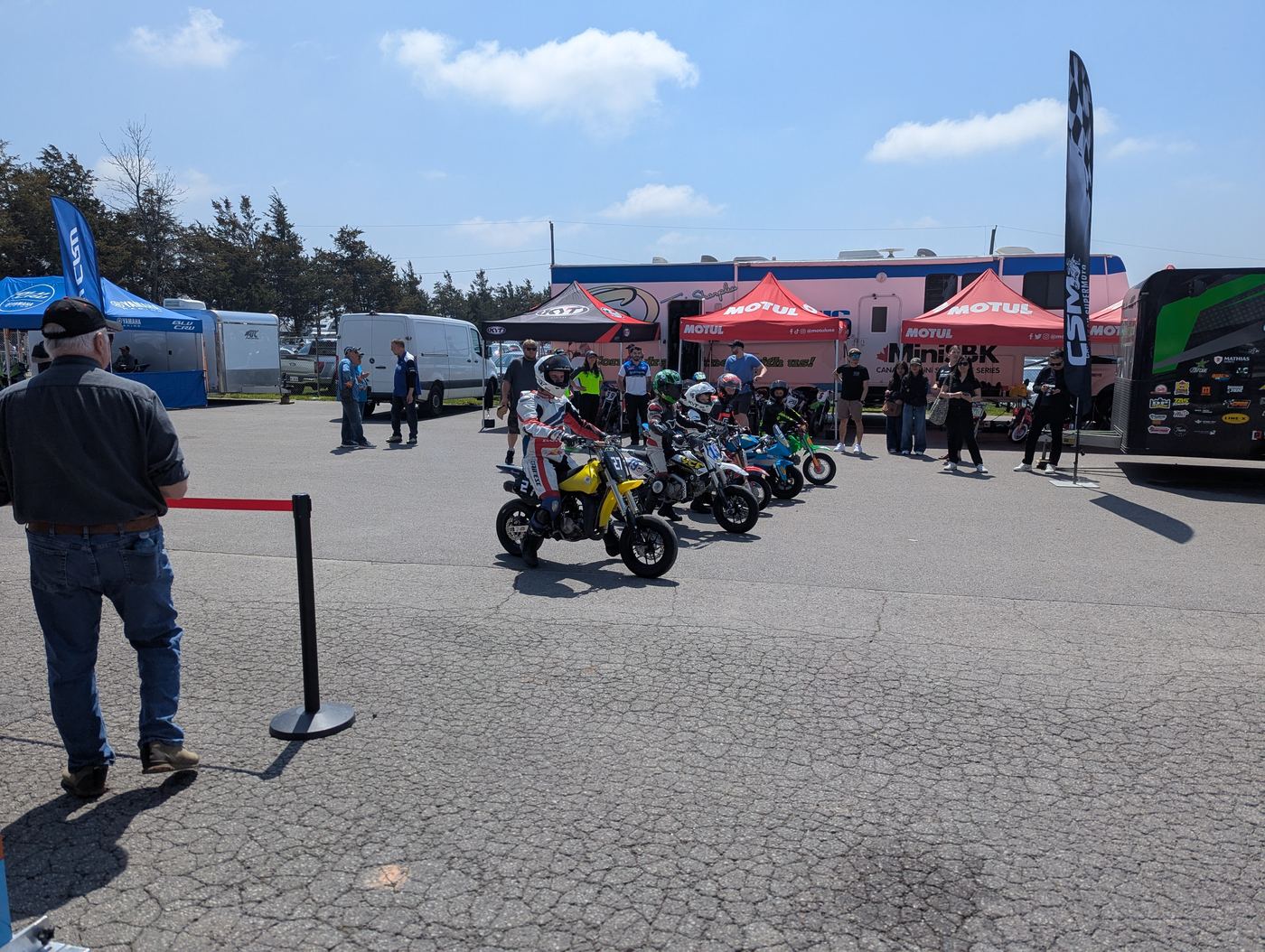 Minimoto bikes lined up in the MiniSBK paddock at Shannonville