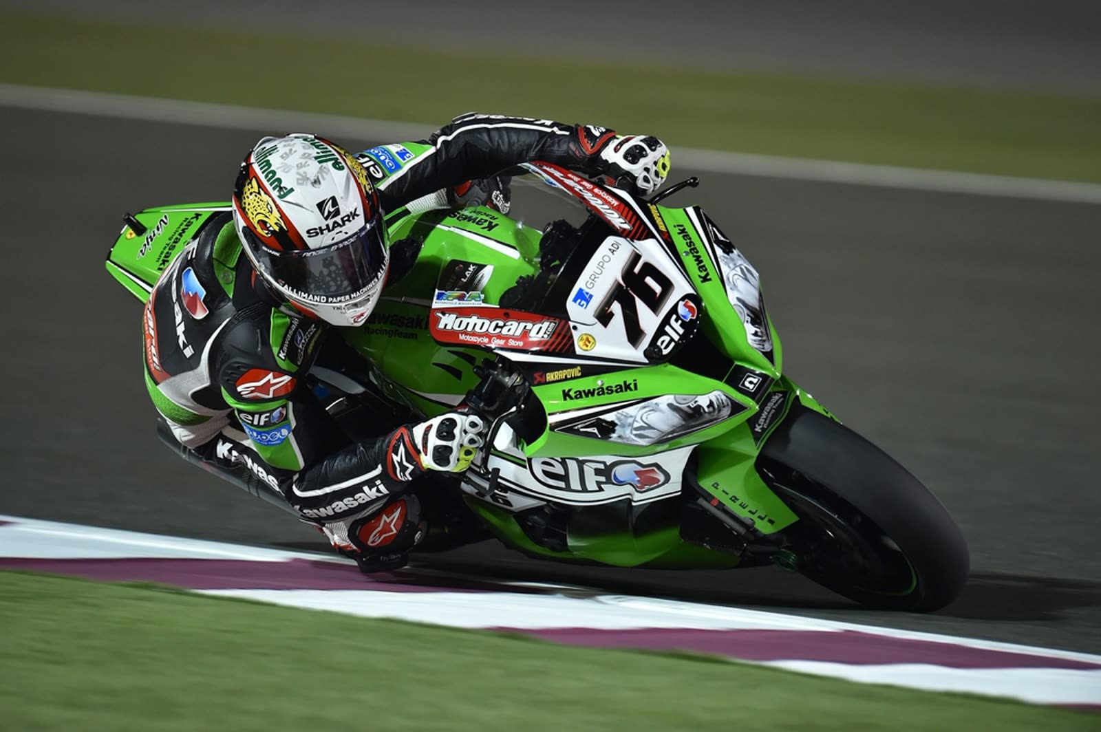 A MotoGP rider racing a Kawasaki on track