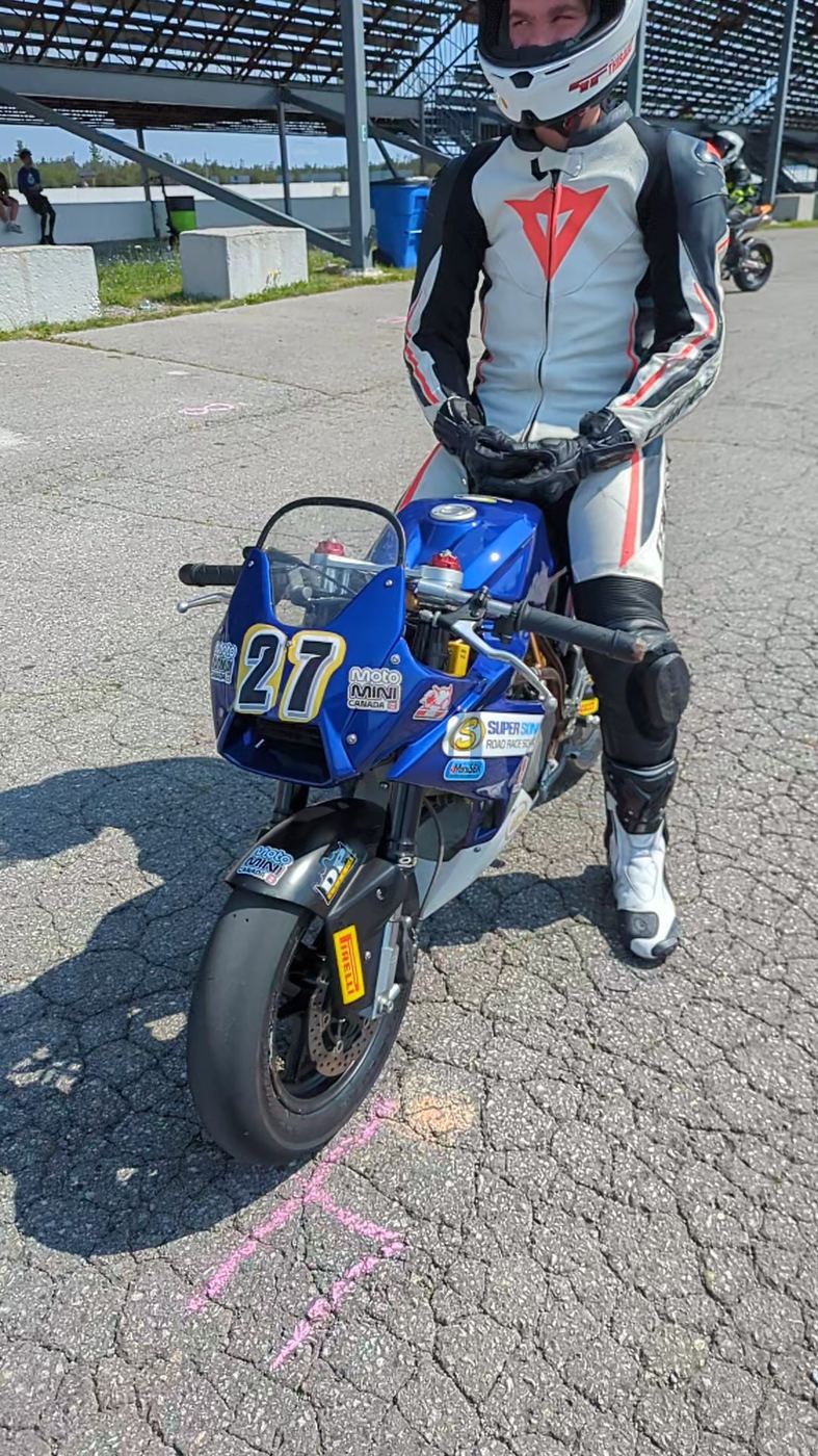 A rider settling onto a bigger bike in the Shannonville paddock