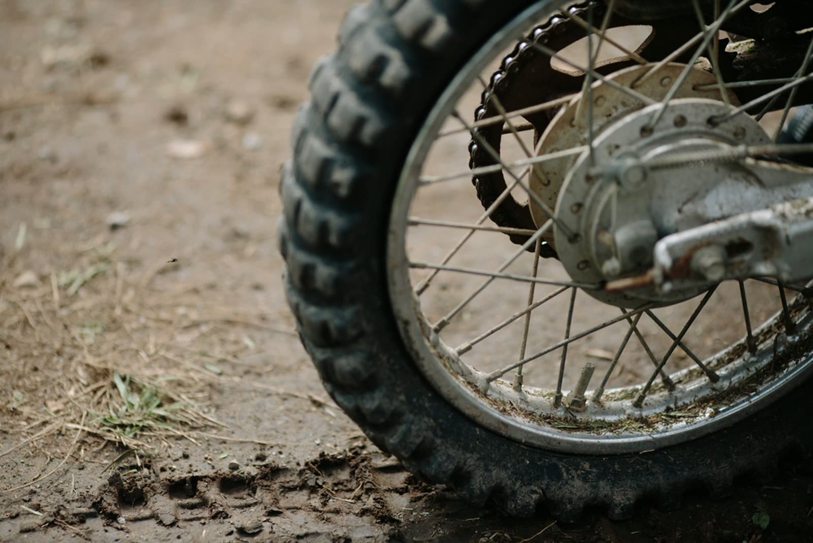 A close-up of a motorcycle tire on a dirt road